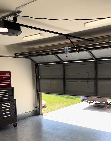 Bent and damaged garage door panel before repair in Tallahassee, FL