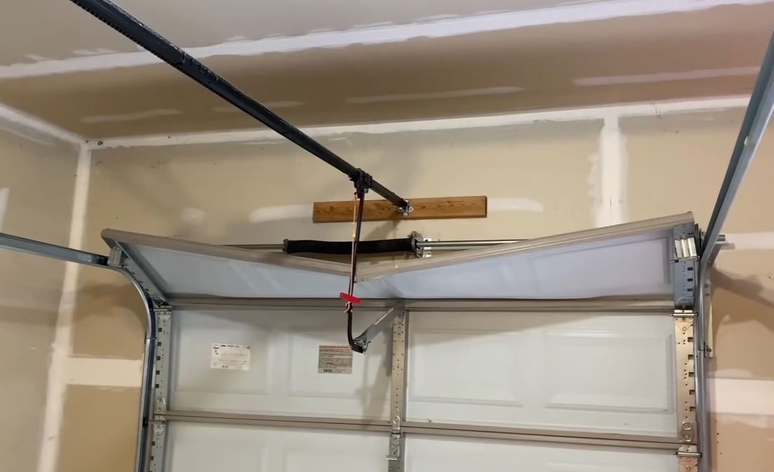 Damaged garage door spring assembly before repair