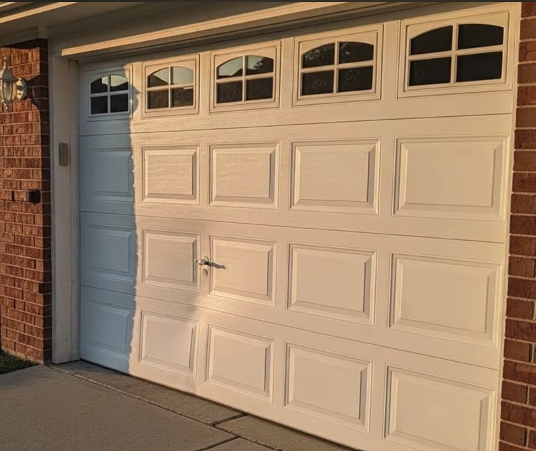 Carriage-style garage door with window panels on a brick home in Tallahassee