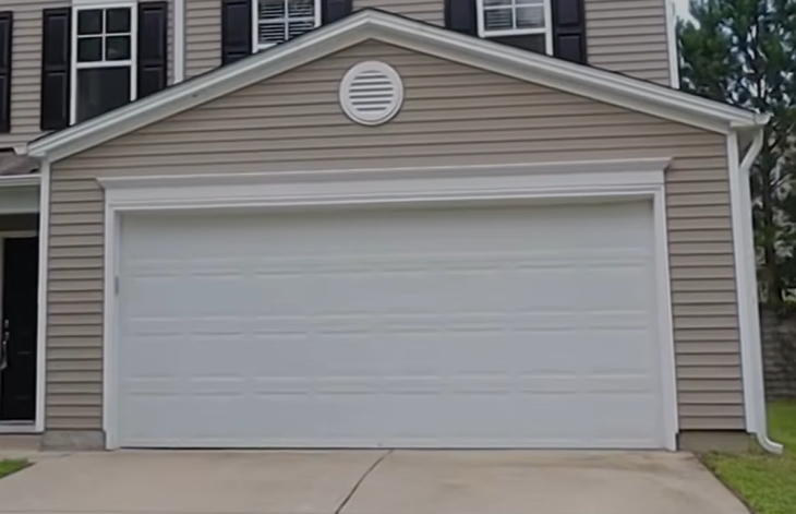 Repaired carriage-style garage door on a two-story home in Tallahassee