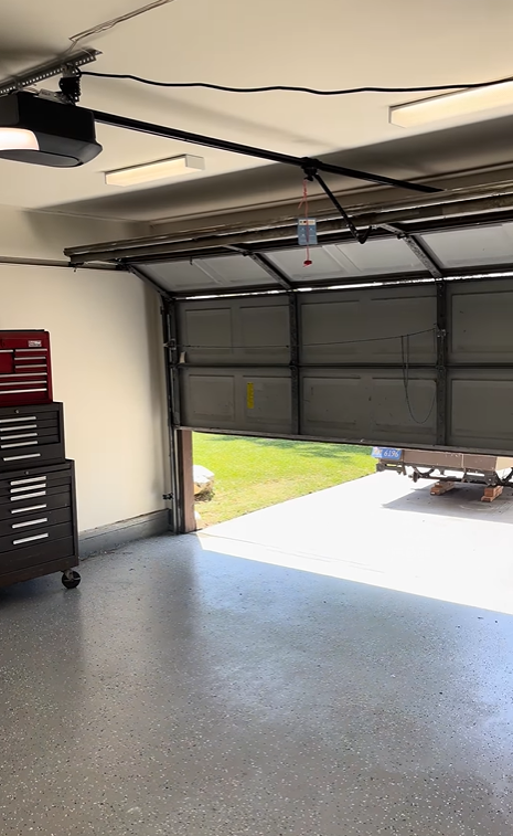 Interior view of a garage door opener rail and track system in a Tallahassee garage